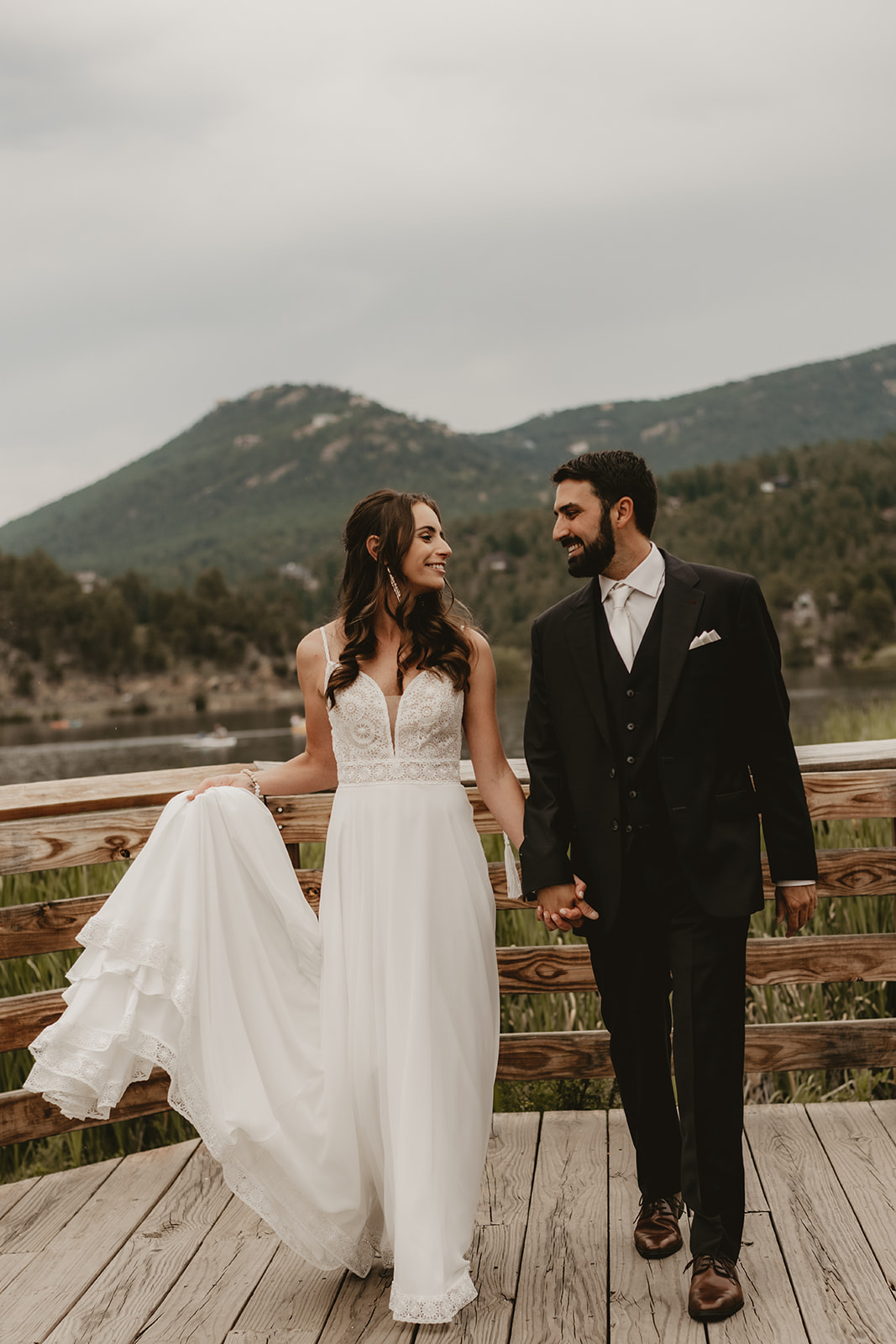 The Evergreen Lake House Wedding in the Colorado Summer by a lake surrounded by the evergreen trees and mountains