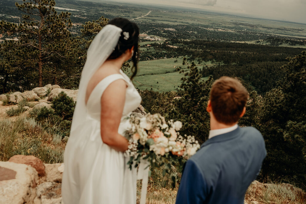 Bride and Groom Overlooking Boulder and the foothills from Sunrise Amphitheater on their summer wedding day