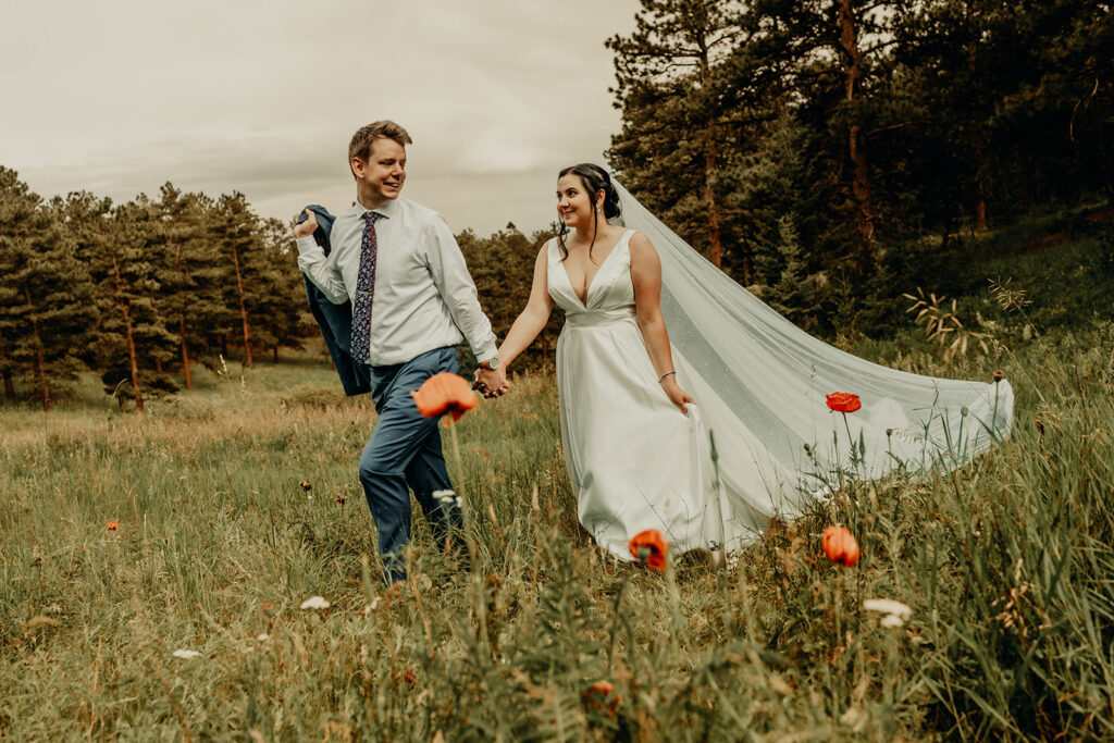 Bride and Groom enjoying the wild flowers. Wedding venues with wild flowers near Boulder, Colorado and Sunrise Amphitheater