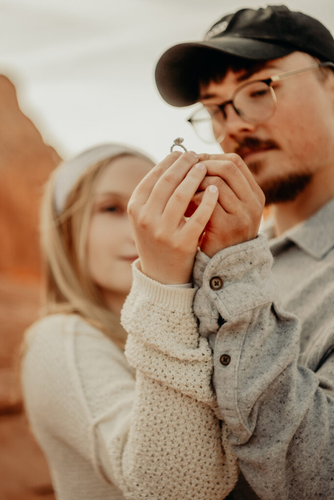 Callie and Nick admiring and holding the ring for the camera to see