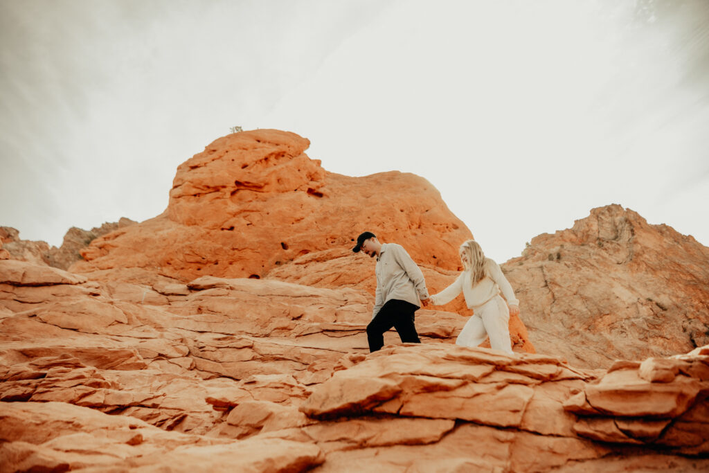 Callie and Nick walking across the Garden of the Gods rock formations. 
