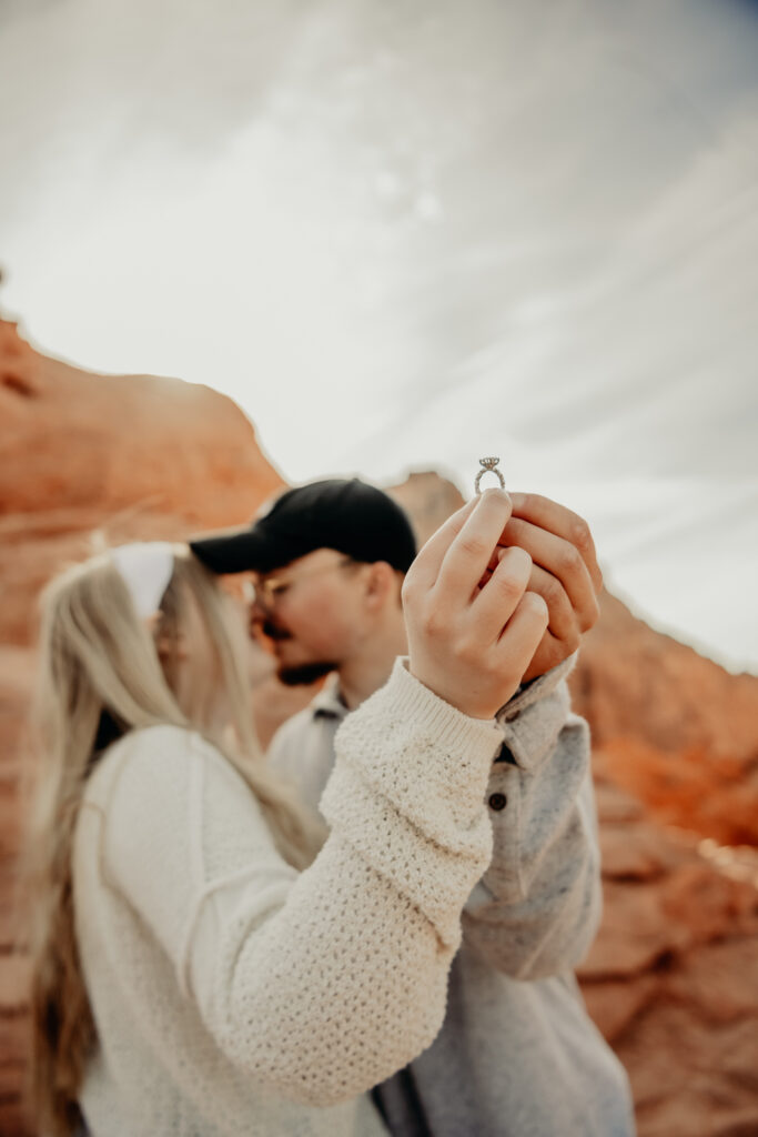 Callie and Nick going for a kiss as they show off the engagement ring for the camera to see first