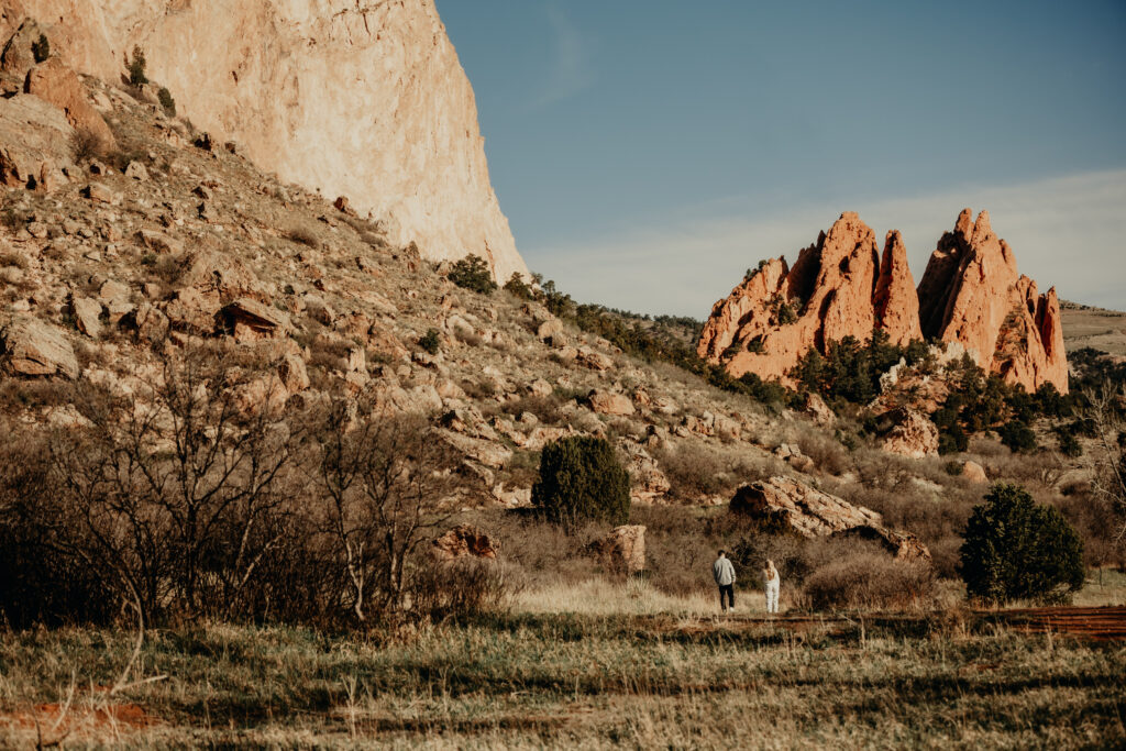 "Photographer walking away with their dog, creating a diversion as Callie and Nick head back towards the car."
