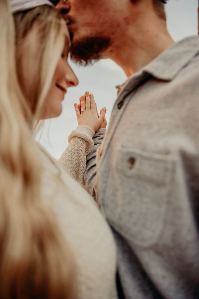 Close-up of Callie's engagement ring on her hand, set against the natural backdrop of Garden of the Gods.