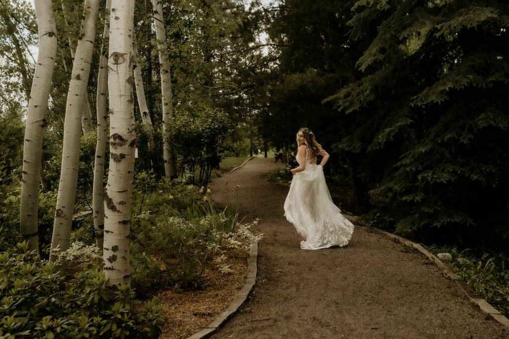 bride running down the pathway at  Yampa River Botanic Gardens