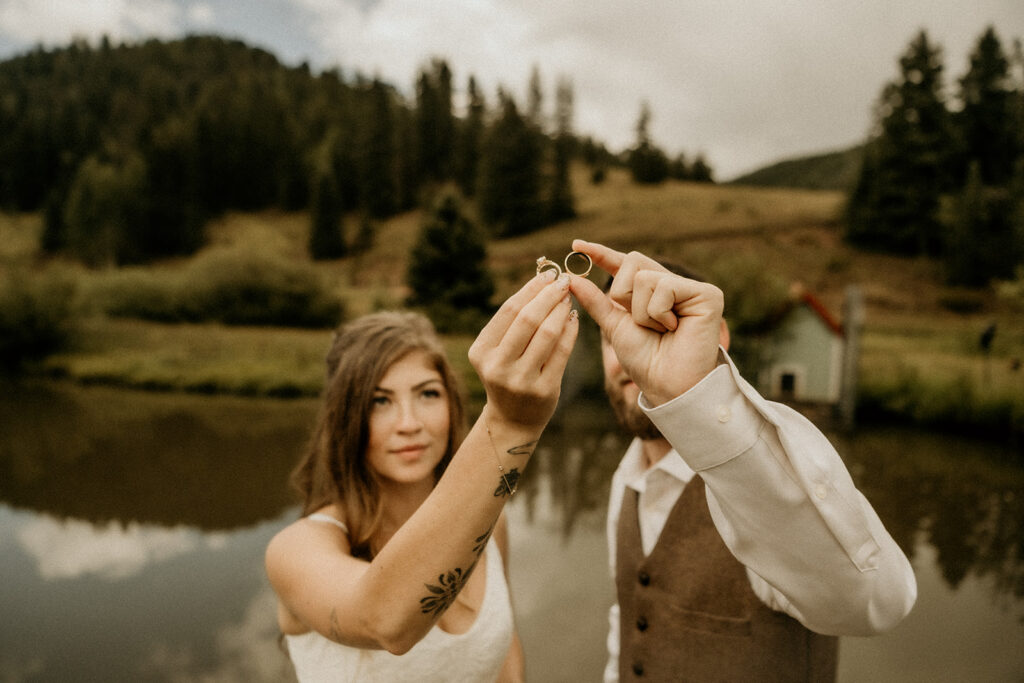 newly weds holding up their wedding bangs and admiring them